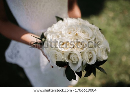 Bridal bouquet, white dress. Red and white roses. Wedding ceremony
