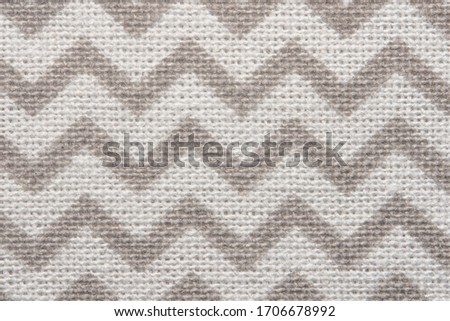 Pattern of gray and white striped zig zag. Macro textile texture