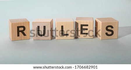 Rules Word In Wooden Cubes on grey blue background