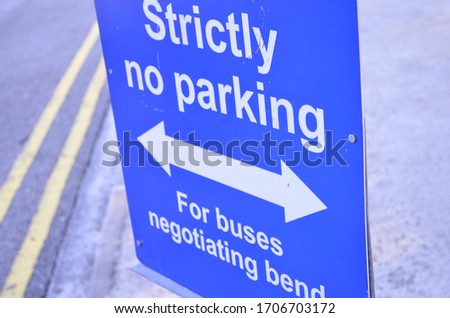 A blue colored signboard saying strictly no parking 
