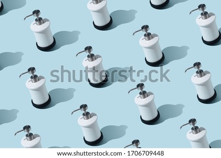 Dispenser for liquid soap, pattern on a blue background.
