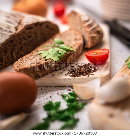 Background with bread, rolls, vegetables and herbs, square format