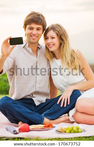 Couple Taking Selfie With Mobile Phone Outdoors