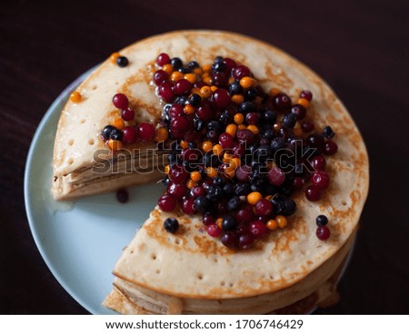 Still life with a stack of pancakes and berries 