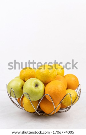 Basket with fruits above white background with copy space