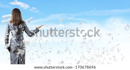 Back view of businesswoman against nature background