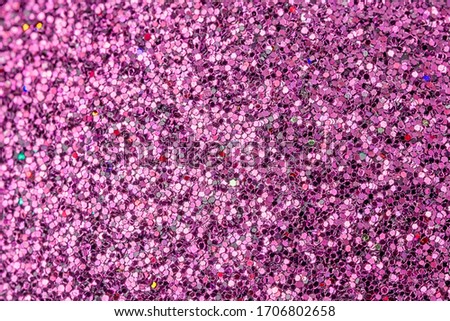Bright picture of purple sparkles close-up. Festive background for sites and layouts.