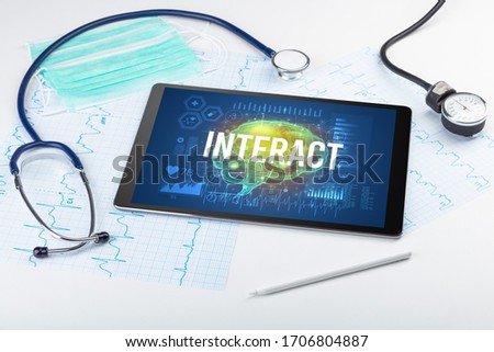 Tablet pc and medical tools with INTERACT inscription, social distancing concept