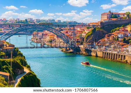 Picturesque, colorful view at old town Porto, Portugal with bridge Ponte Dom Luis over Douro river. Oporto, touristic mediterranean city of culture, architecture, wine, sport and gastronomy. Royalty-Free Stock Photo #1706807566