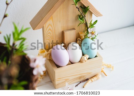 Happy Easter day. Easter decor. Painted eggs in a wooden house. Spring. Easter eggs.