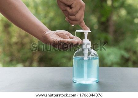 Pressing the alcohol gel into the hand