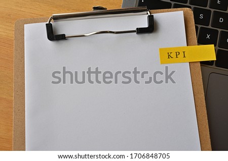The word "KSF" is stamped on a yellow  note on a clipboard.