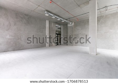 empty pure commercial office building undecorated in gray colors.open space office Royalty-Free Stock Photo #1706878513