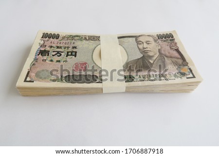 10,000 yen bills in Japanese yen spread out on the front.The bills in the photo are Japanese bills.