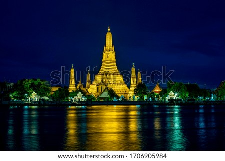 golden shining temple by the Chao Phraya River at dusk