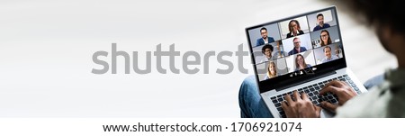 Man Working From Home Having Online Group Videoconference On Laptop Royalty-Free Stock Photo #1706921074