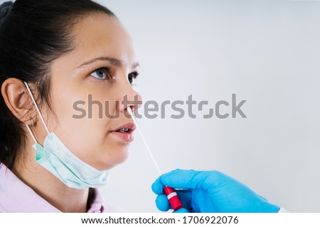 Doctor Taking Mouth Fluid Swab Sample From Throat Royalty-Free Stock Photo #1706922076