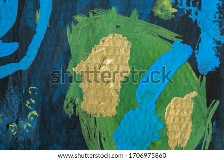 Gold spots on a green circle and on a blue background children’s gouache drawing on cardboard