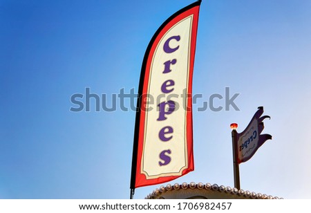 Crepes as text on a flag with blue background.