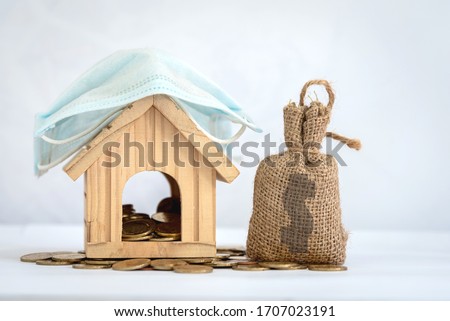 The concept is at home to prevent viruses, money, health care in Cornavirus (COVID-19), a pile of gold medals under a surgical mask with a copy area. Royalty-Free Stock Photo #1707023191
