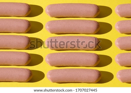 Many sausages pattern on bright yellow background
