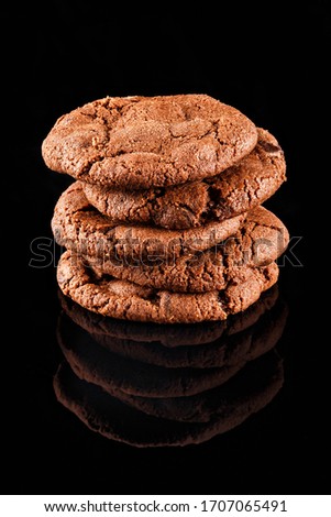 Classic chocolate homemade cookies in black background. Confectionery photography concept.