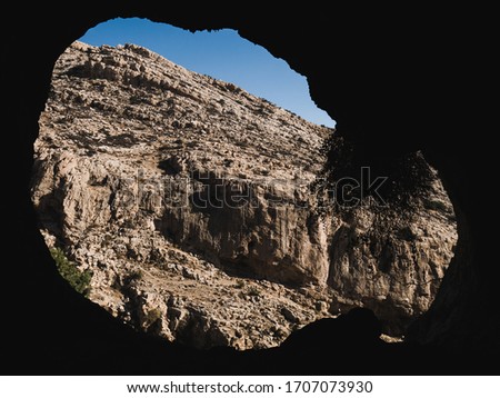 View from cave to valley rocks in desert Israel