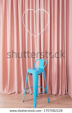 
neon inscription love on a pink curtain