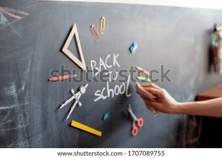 Back to school. Tools for education on chalkboard background. Banner. Hand write with chalk. Blurred. 