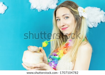 Hawaiian woman with coconut cocktail close up on the blue background.