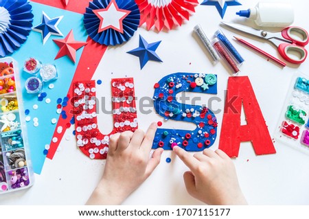 Diy 4th of July decor USA letters color American flag. Patriotic holiday. Process kid children craft. Rocket with fireworks Royalty-Free Stock Photo #1707115177