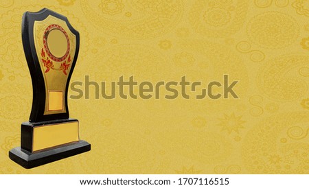A golden trophy isolated  in golden textured background