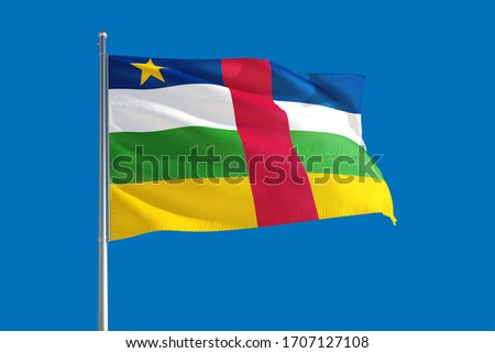 Central African Republic national flag waving in the wind on a deep blue sky. High quality fabric. International relations concept. Royalty-Free Stock Photo #1707127108