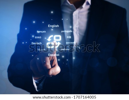 Online Translator. Hand tapping on translate button. Symbol of translation and top ten internet users languages.Translator  language course and e-learning concept. 
 Royalty-Free Stock Photo #1707164005