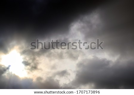 Beautiful cloud formations with sunlight beam shining in a sunset sky