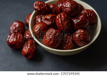 Bowl of dried jujube, also known as Chinese date and fructus jujubae. Royalty-Free Stock Photo #1707199345