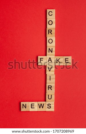 Coronavirus fake news word written on wood block. False concept