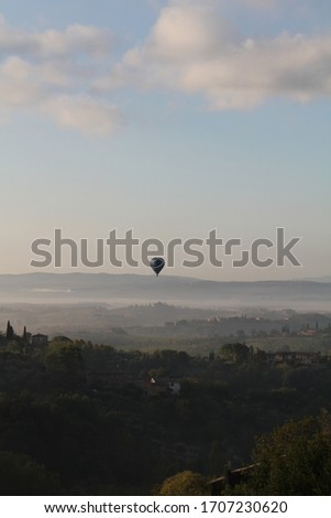 Lonely air balloon on the Tuscan landscapes
