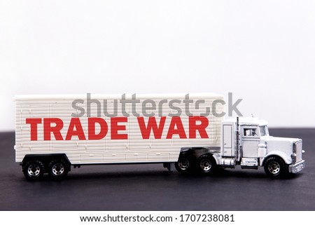 Trade War, word concept written on board a lorry trailer on a dark table and light background