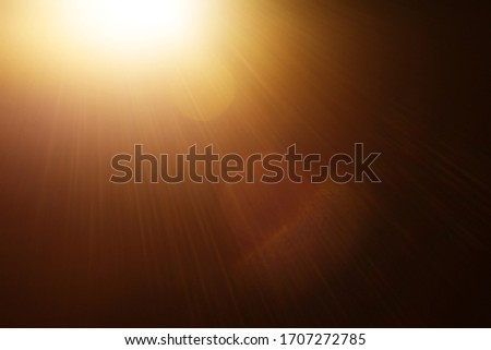 Easy to add lens flare effects for overlay designs or screen blending mode to make high-quality images. Abstract sun burst, digital flare, iridescent glare over black background. Royalty-Free Stock Photo #1707272785