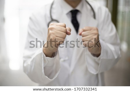 Close up of doctor holding fists