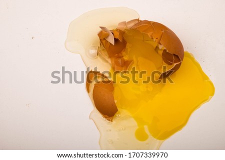A broken chicken egg on a white background. Close up.