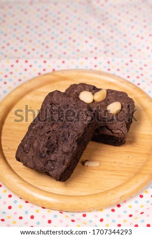 brownies with macadamia nuts on wooden background