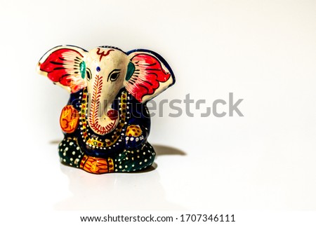 Small colored terracotta Ganesh. Copy space.