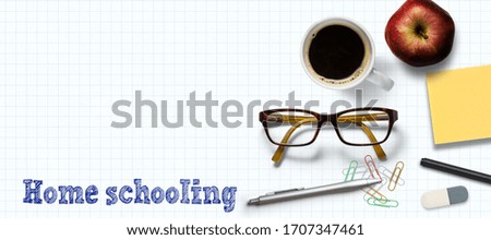 message HOME SCHOOLING with sticky notes and pens on a white paper background