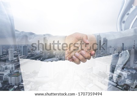 double exposure business handshake with modern cityscape between business man and business woman greeting deal partner successful together concept.