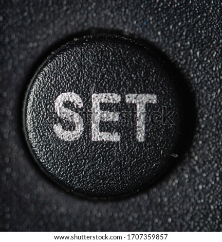 Set button with dark background. Macro photography.
