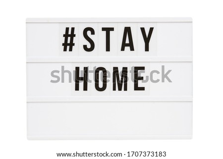 'Stay home' hashtag written in the light box with the lights off