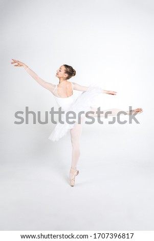 Young ballerina practising ballet moves in the studio