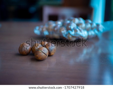 Organic Macadamia nut on a wooden table.